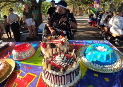 Me sitting in front of a table full of goodies and the cake. While people singing Happy Birthday