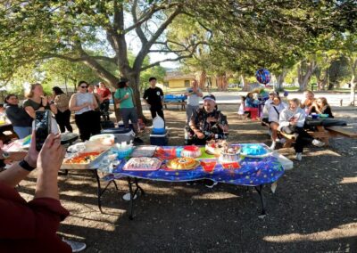 Me sitting in front of a table full of goodies and the cake. While people singing Happy Birthday