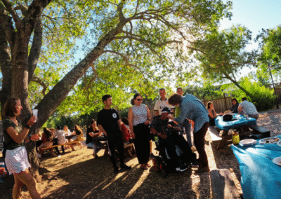 Max wiping my eyes, surrounded by some researchers, and other friends sitting around