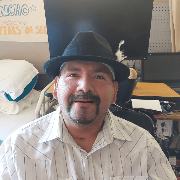 Pancho Ramirez wearing a white shirt and a black cowboy hat.