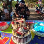 Birthday of 2022 Me sitting in front of a table full of goodies and the cake. While people singing Happy Birthday